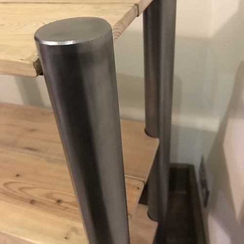 Reclaimed wood shelves with handcrafted metal tubular legs