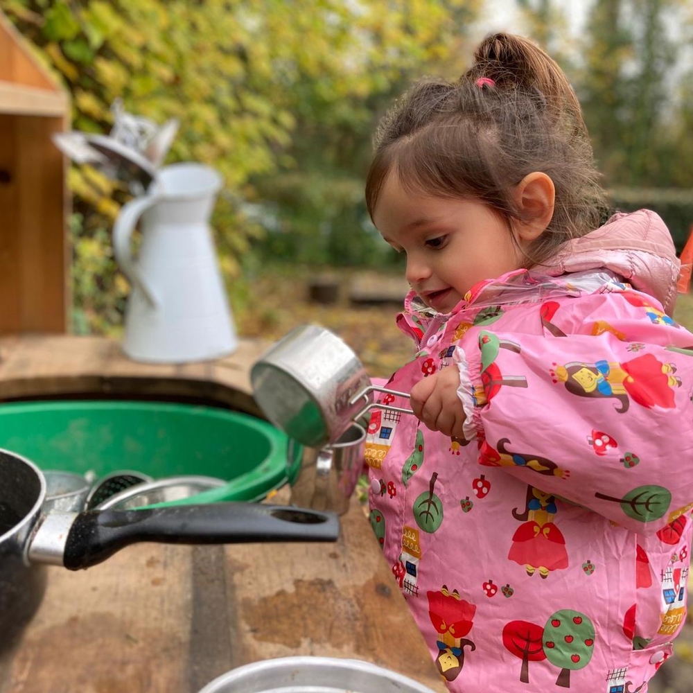 Mud kitchen time in outdoor preschool
