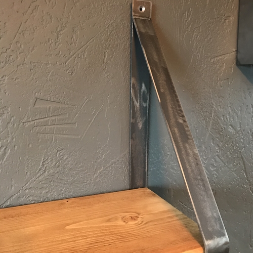 Rustic scaffold board shelf with handcrafted metal brackets