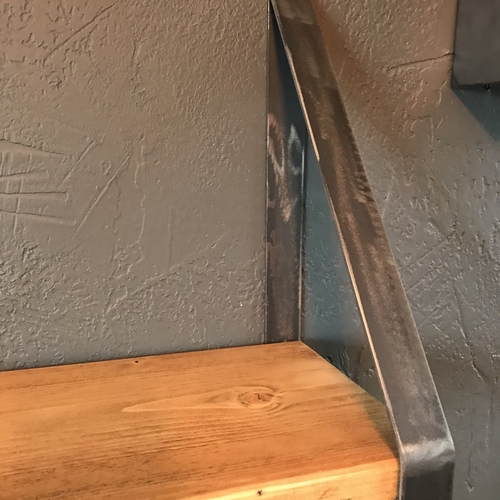 Rustic scaffold board shelf with handcrafted metal brackets