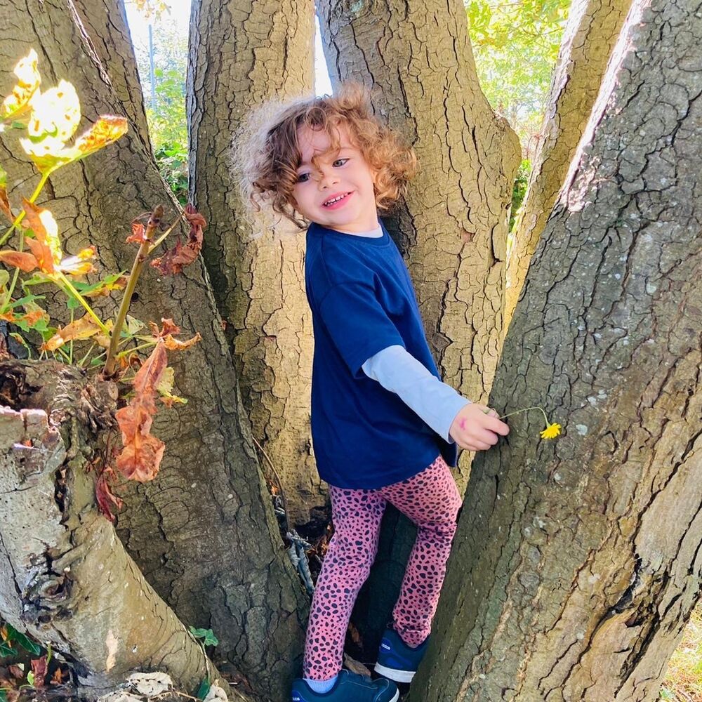 Children exploring nature at outdoor learning session in West Sussex