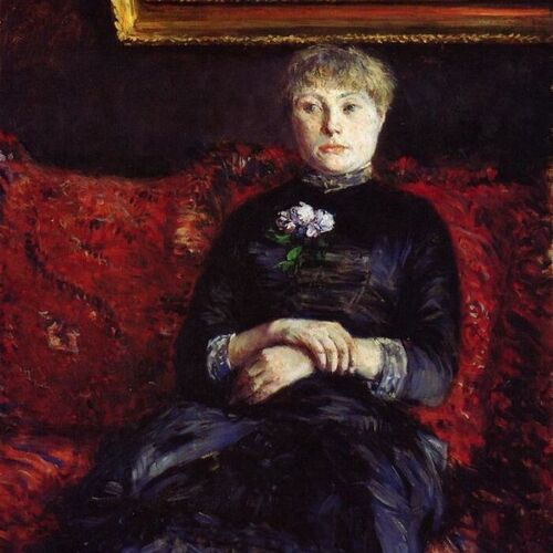Woman Sitting on a Red-Flowered Sofa