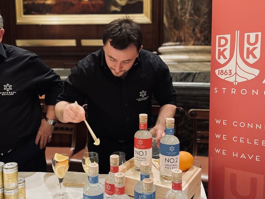 Sasha from Vintersol Distillery using chopsticks to prepare aquavit and tonics