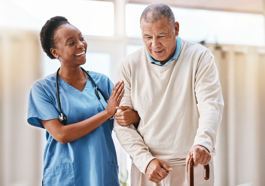Female physiotherapist working with elderly patient