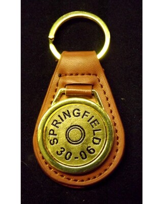 Gold plated representation of a head stamp on a leather key fob
