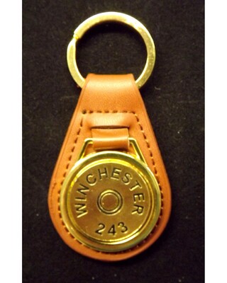 Gold plated representation of a head stamp on a leather key fob