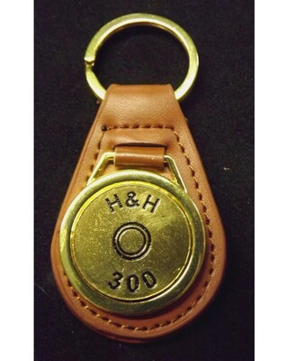 Gold plated representation of a head stamp on a leather key fob