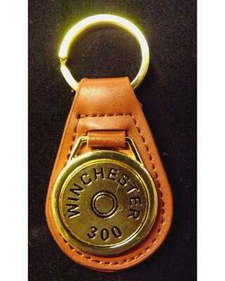 Gold plated representation of a head stamp on a leather key fob