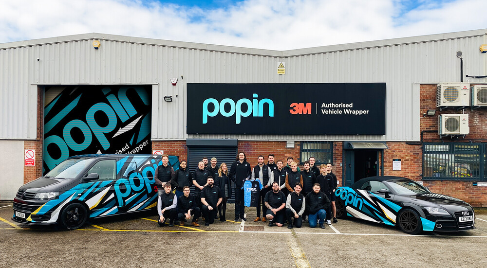 Rory Thornton of Cardiff Rugby and members of staff from his sponsors Popin Graphics