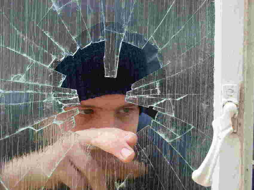 Burglar breaking into a home