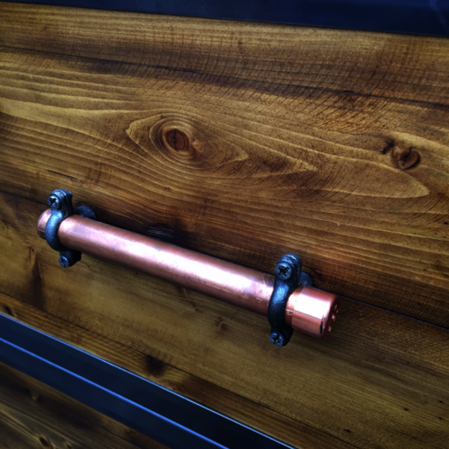 Industrial chest of drawers with copper handles and metal detail