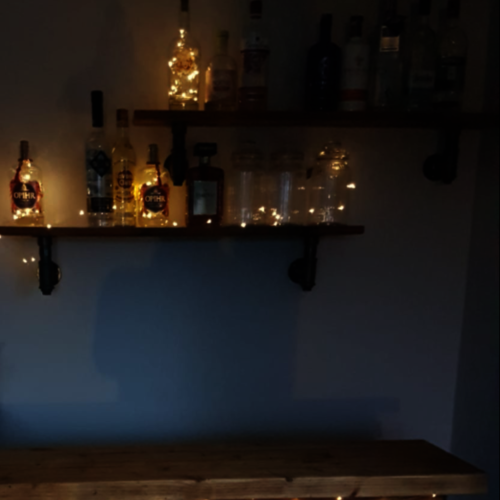 Reclaimed rustic wood shelf with industrial pipe brackets