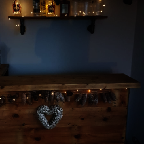 Reclaimed rustic wood shelf with industrial pipe brackets