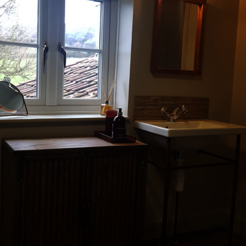 Bespoke bathroom cupboard with rusty doors