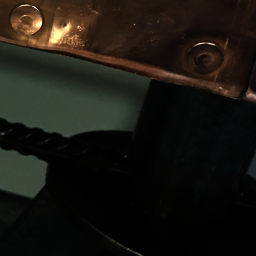 Copper top coffee table with upcycled old axle stand legs