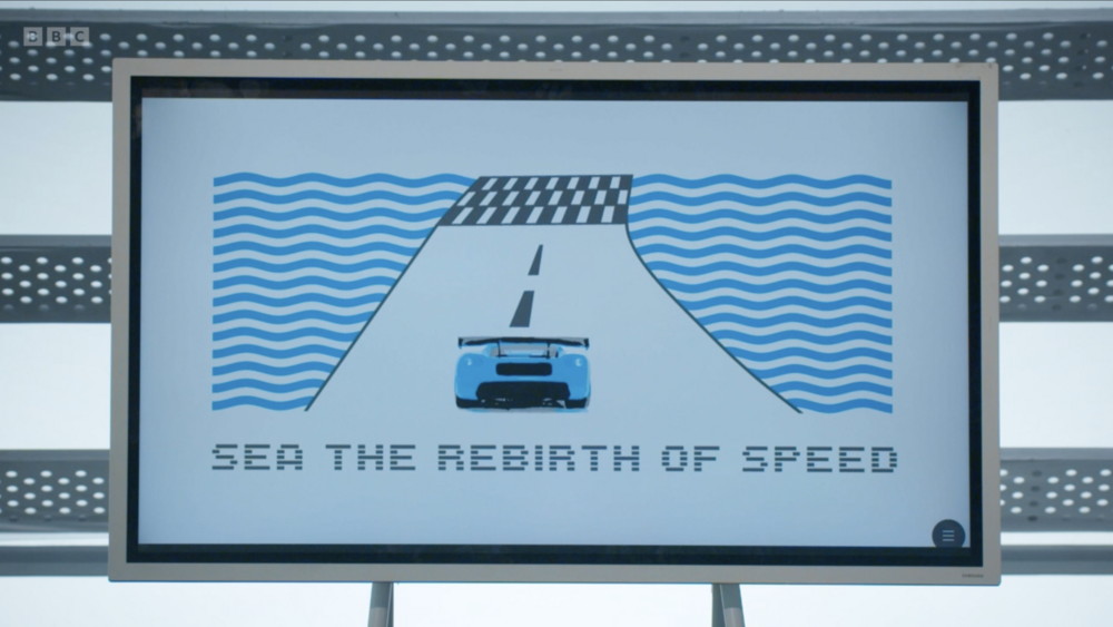 A screen with a picture of a race car logo on it from the apprentice