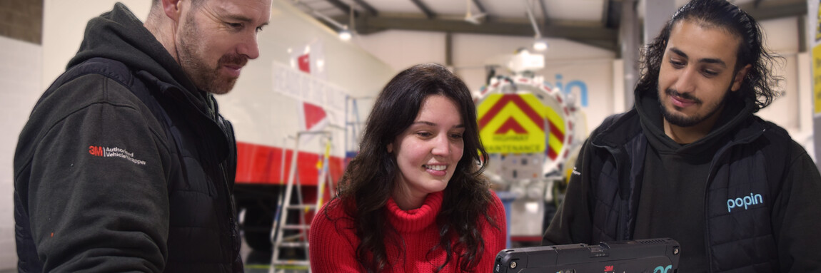 Popin Graphics staff smiling on workshop floor